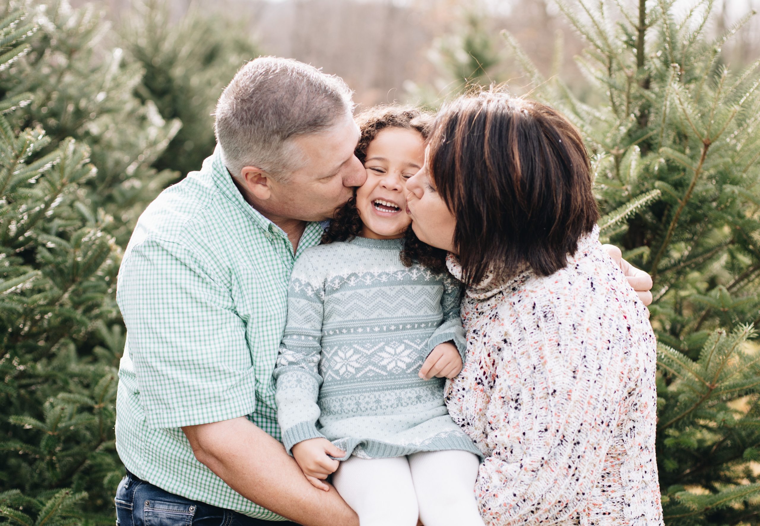 couple kissing child Photo for dioceses to use for their foster support webpage